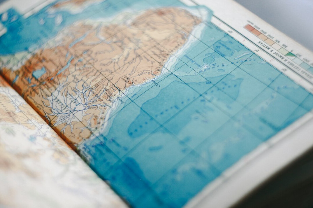 Magnifying glass resting on an old map