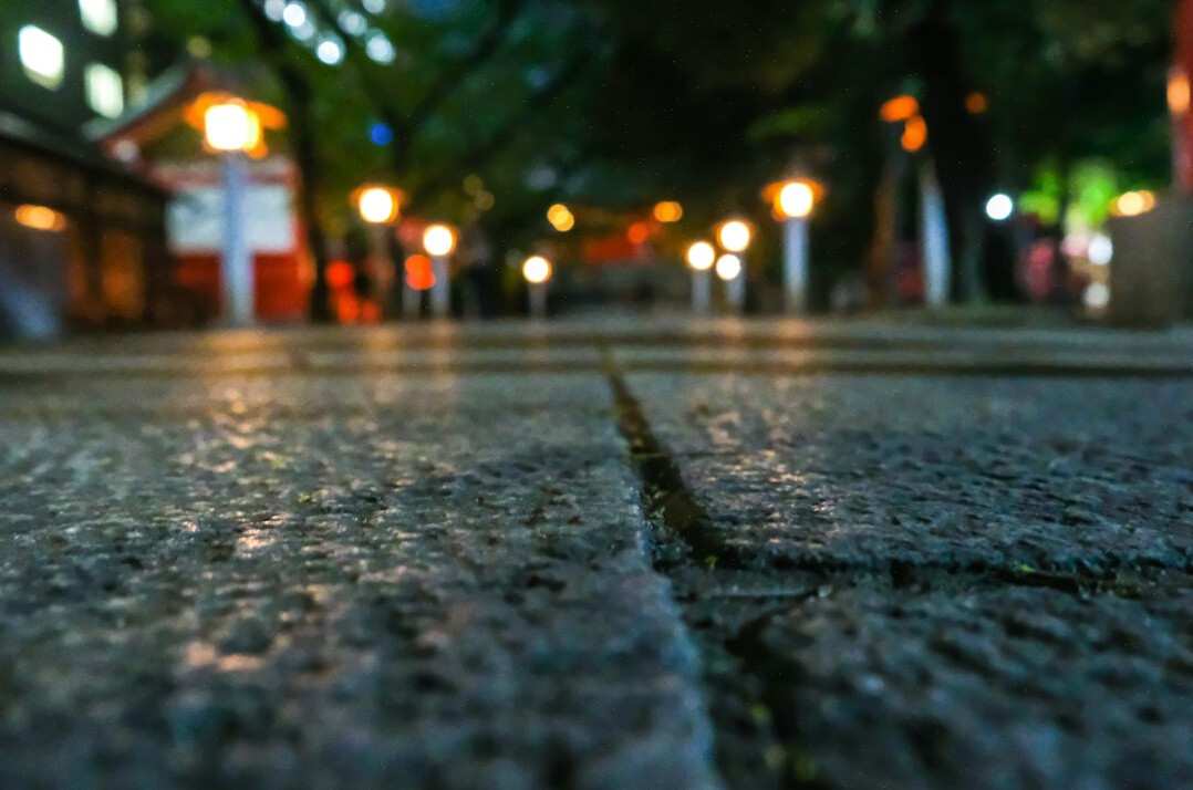 Empty cobblestone street at night under a streetlamp